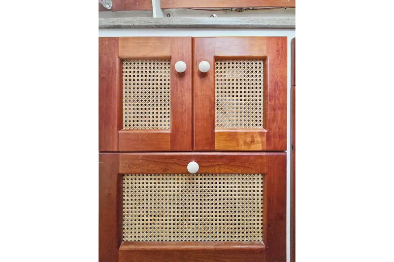 Surfer Girl Yacht Photos Pics Wooden cabinet doors with woven cane panels on a 2018 Maine Cat 38 LS.