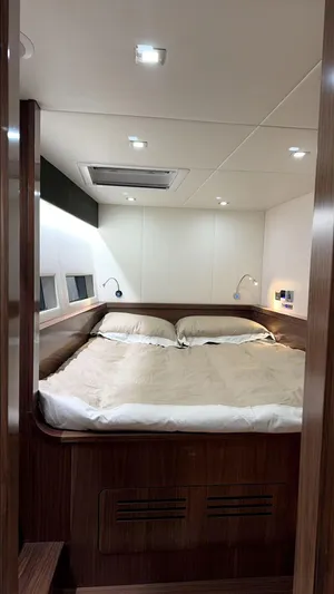  Yacht Photos Pics 2024 Mazarin 55 Catamaran Hybrid bedroom with modern design and cozy bedding.