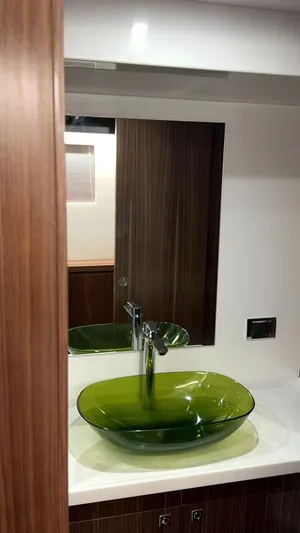  Yacht Photos Pics 2024 Mazarin 55 Catamaran Hybrid bathroom with green glass sink and modern design.