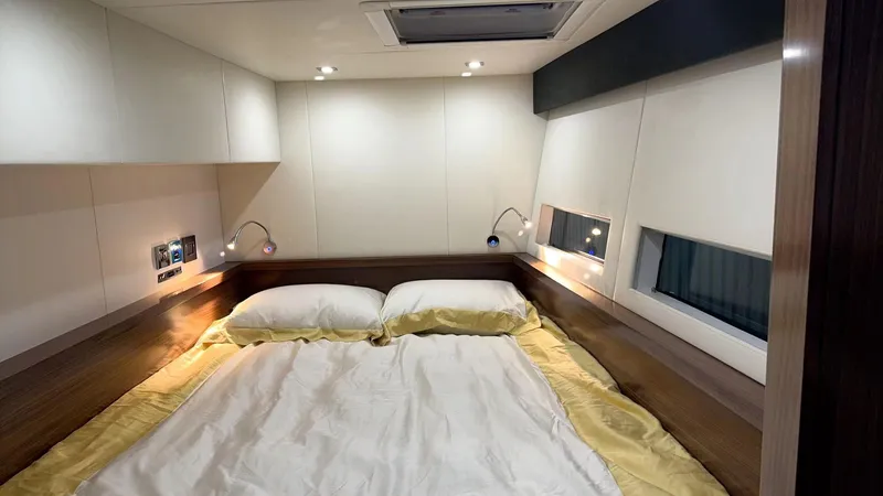  Yacht Photos Pics Luxurious bedroom interior of 2024 Mazarin 55 Catamaran Hybrid with modern lighting and cozy bedding.
