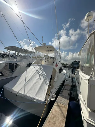  Yacht Photos Pics 2003 Riviera 40 Convertible yacht docked at a marina under a sunny sky.