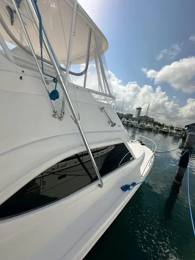  Yacht Photos Pics 2003 Riviera 40 Convertible yacht docked at a marina on a sunny day.