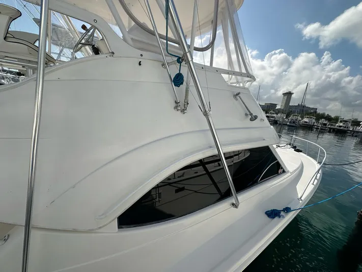  Yacht Photos Pics 2003 Riviera 40 Convertible yacht docked at marina on a sunny day.