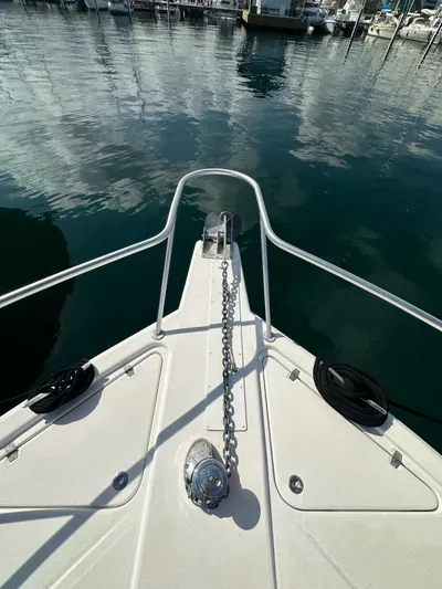  Yacht Photos Pics Bow of 2003 Riviera 40 Convertible yacht with anchor chain in marina.