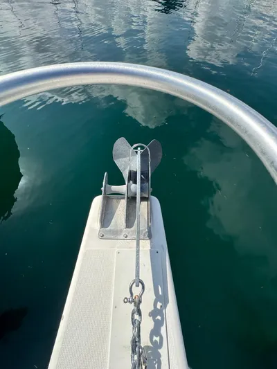  Yacht Photos Pics Bow of 2003 Riviera 40 Convertible with anchor and chain in water.