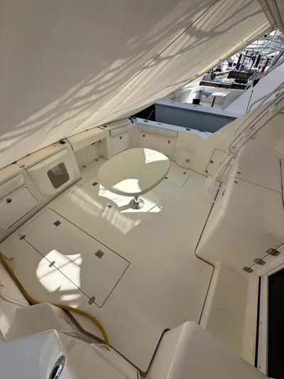  Yacht Photos Pics 2003 Riviera 40 Convertible yacht deck with white seating and table.