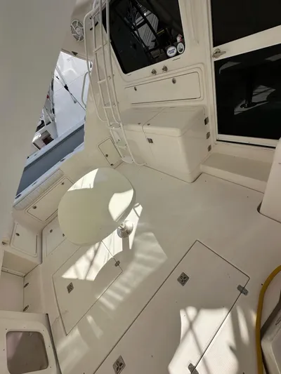  Yacht Photos Pics 2003 Riviera 40 Convertible yacht deck with seating and table.