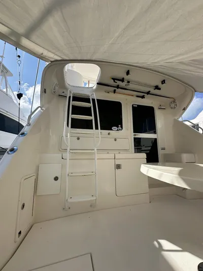  Yacht Photos Pics 2003 Riviera 40 Convertible yacht interior with ladder and seating area.