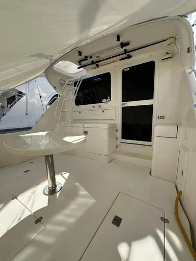  Yacht Photos Pics 2003 Riviera 40 Convertible yacht interior with table and storage compartments.