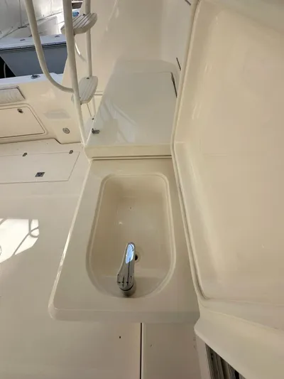  Yacht Photos Pics 2003 Riviera 40 Convertible boat interior with sink and storage compartments.