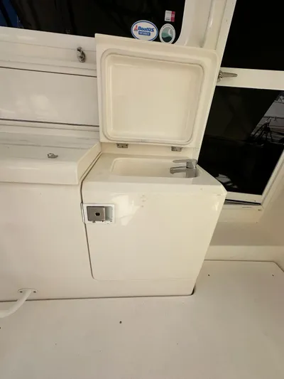  Yacht Photos Pics 2003 Riviera 40 Convertible boat interior sink and storage compartment.