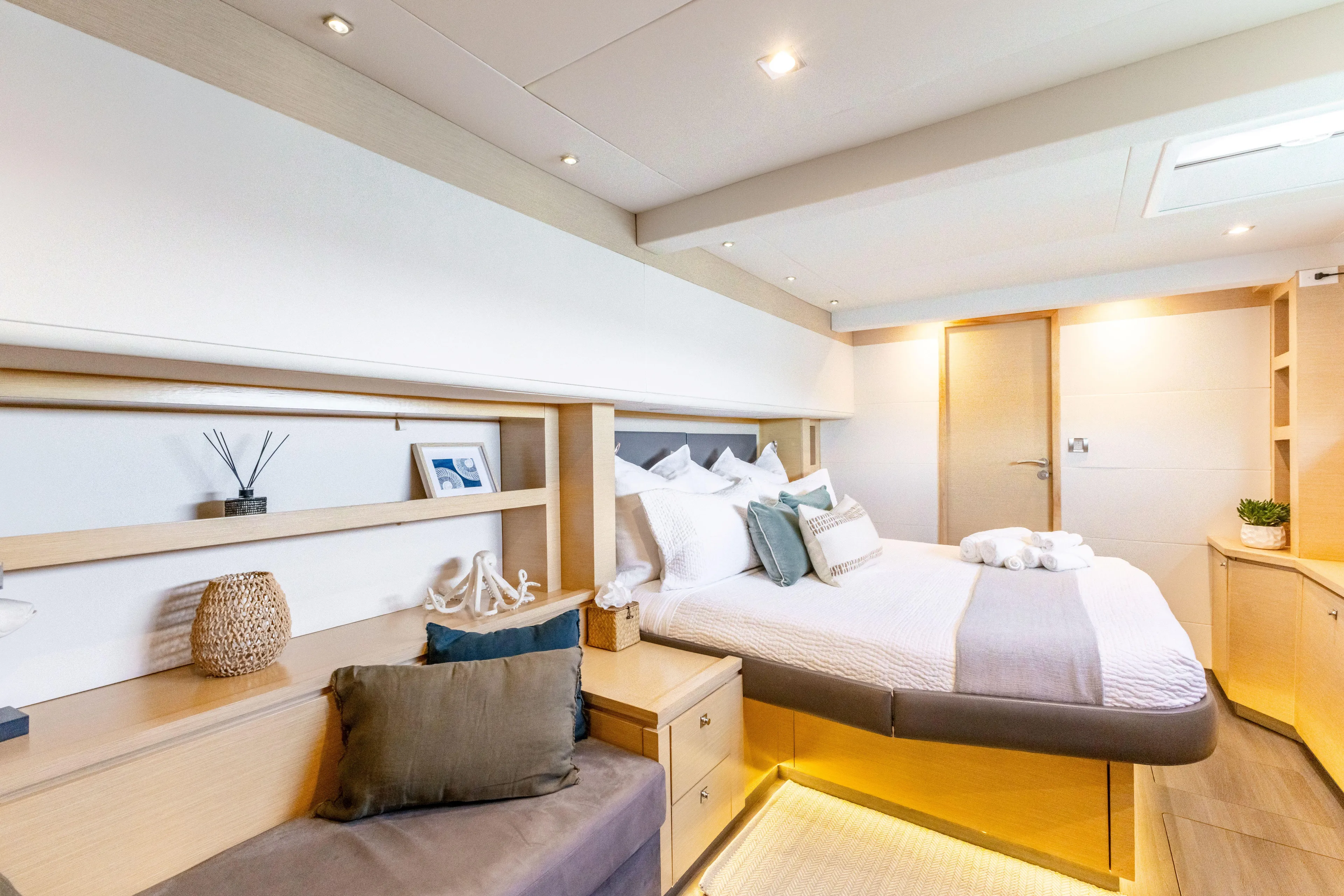  Yacht Photos Pics Luxurious cabin interior of 2017 Fountaine Pajot Victoria 67 yacht, featuring elegant decor and cozy bedding.