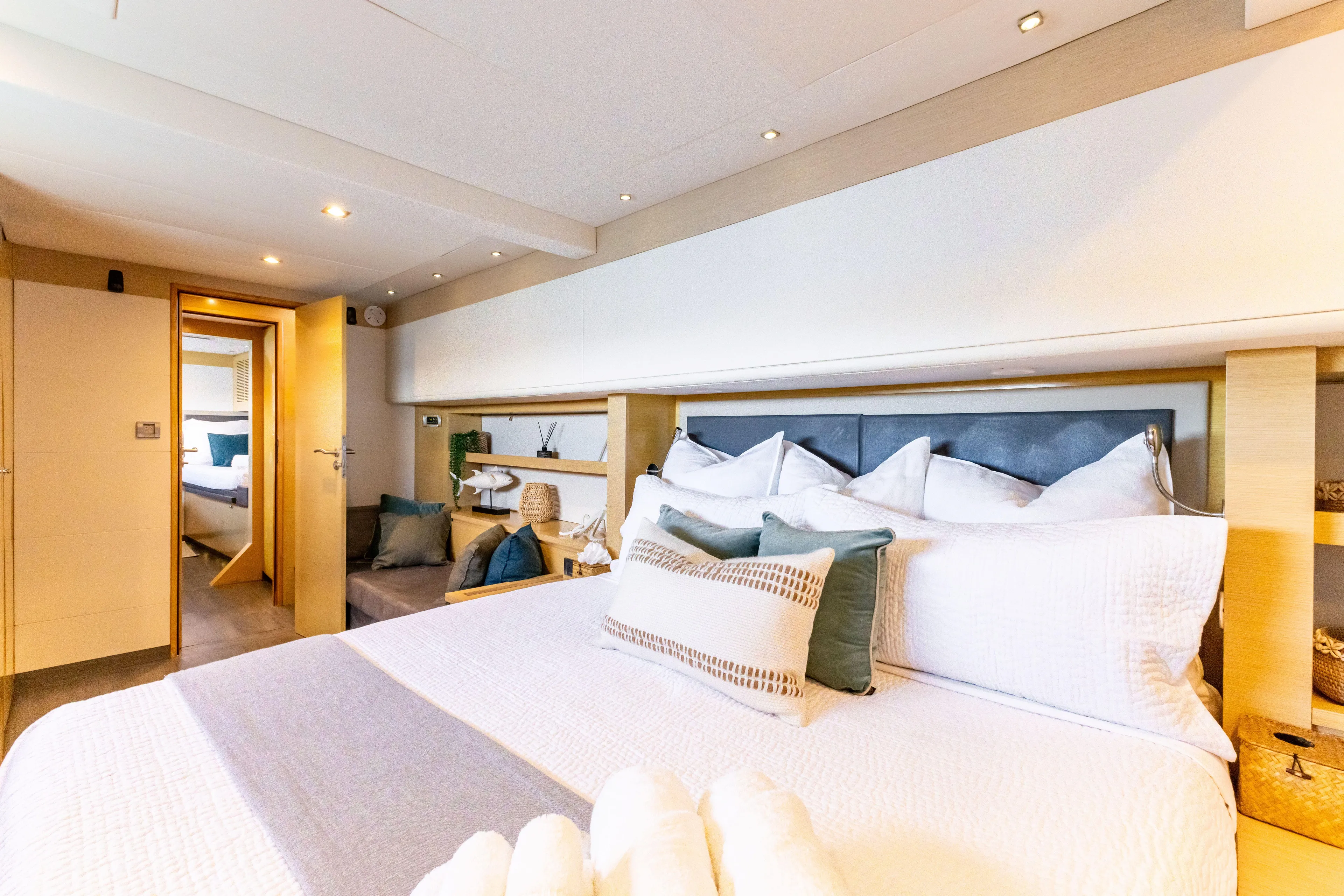  Yacht Photos Pics Luxurious bedroom interior of 2017 Fountaine Pajot Victoria 67 yacht, featuring elegant bedding.
