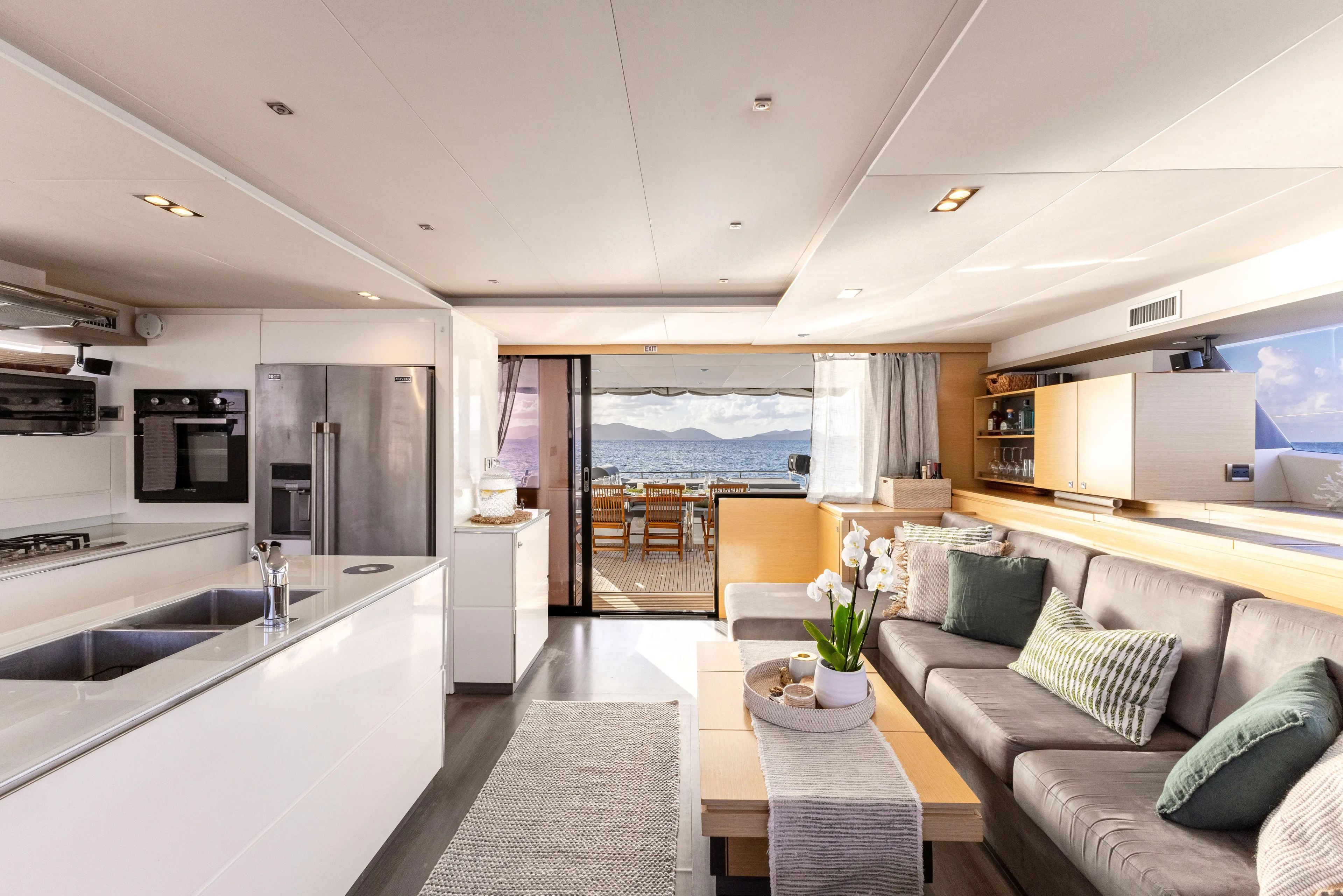  Yacht Photos Pics Luxurious interior of 2017 Fountaine Pajot Victoria 67 yacht with modern kitchen and seating area.