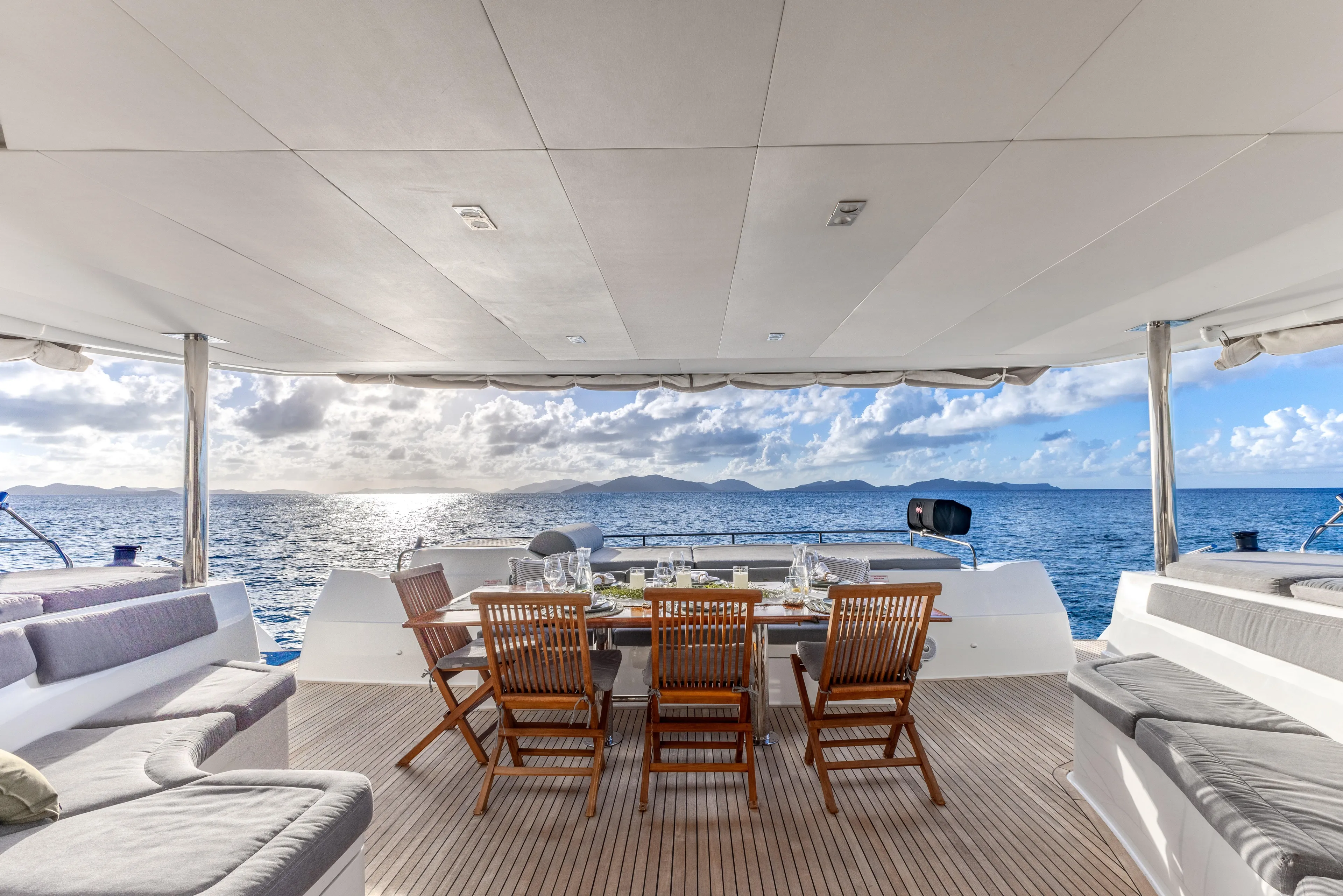  Yacht Photos Pics Luxurious 2017 Fountaine Pajot Victoria 67 yacht with elegant outdoor dining area at sea.