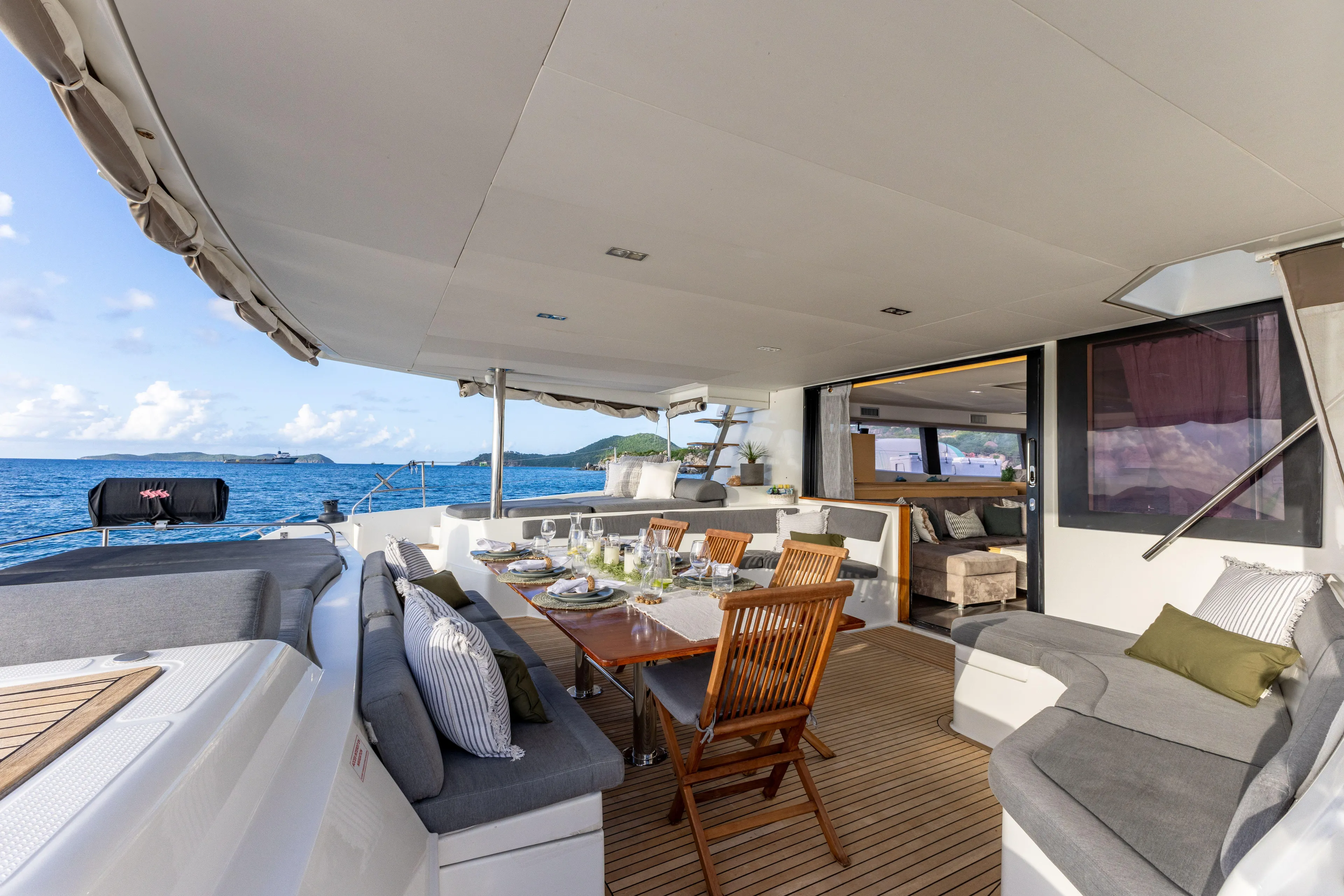  Yacht Photos Pics Luxurious 2017 Fountaine Pajot Victoria 67 yacht with elegant outdoor seating and dining area.