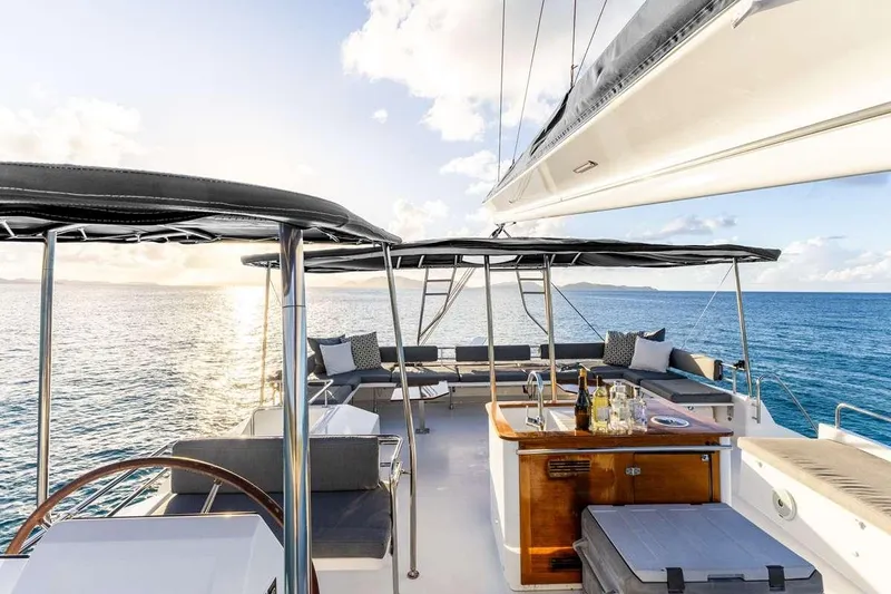  Yacht Photos Pics Luxurious 2017 Fountaine Pajot Victoria 67 yacht with elegant outdoor seating and ocean view.