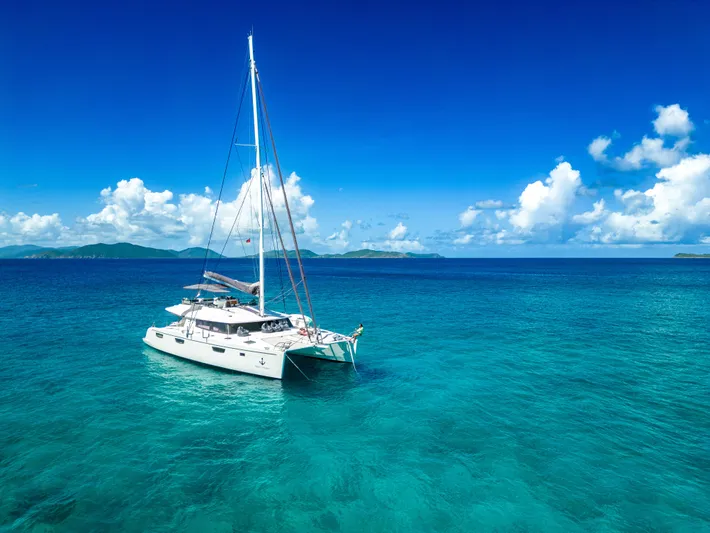  Yacht Photos Pics Fountaine Pajot Victoria 67 catamaran sailing in clear blue ocean, 2017 model.