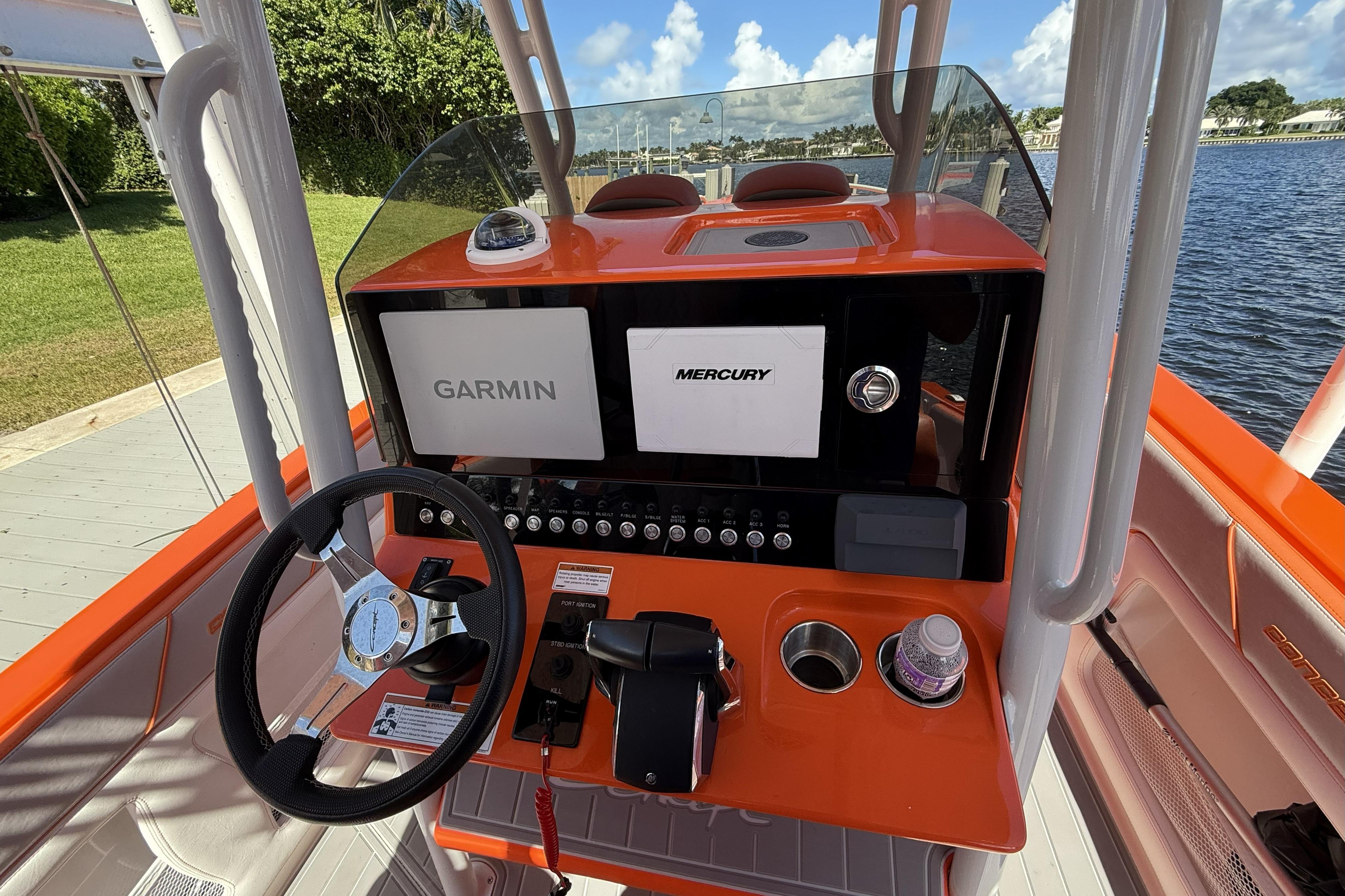 Orange helm of 2025 Concept 32' CC boat with Garmin and Mercury displays.