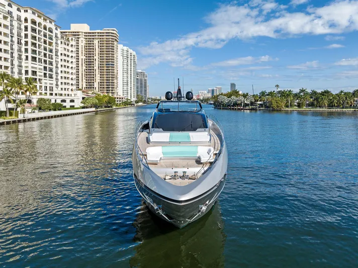 Beso Yacht Photos Pics 2024 Riva 102 Corsaro Super yacht cruising in a scenic urban waterway.