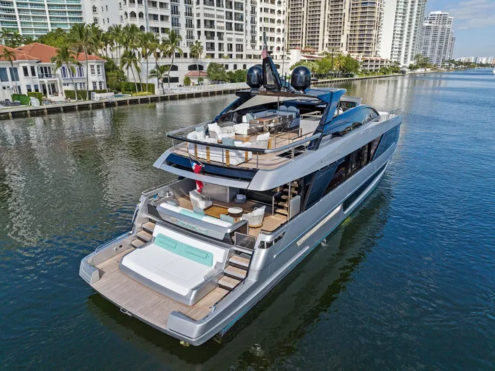 Beso Yacht Photos Pics Luxury 2024 Riva 102 Corsaro Super yacht cruising near waterfront buildings.