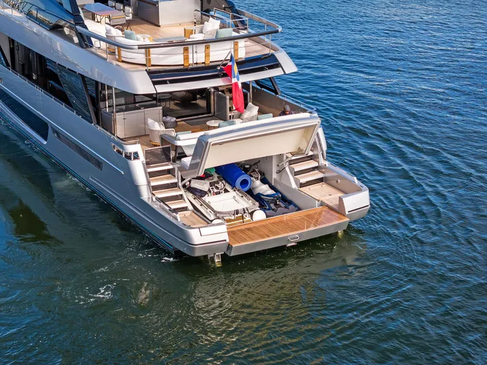 Beso Yacht Photos Pics Luxury 2024 Riva 102 Corsaro Super yacht on water, showcasing open deck and storage area.