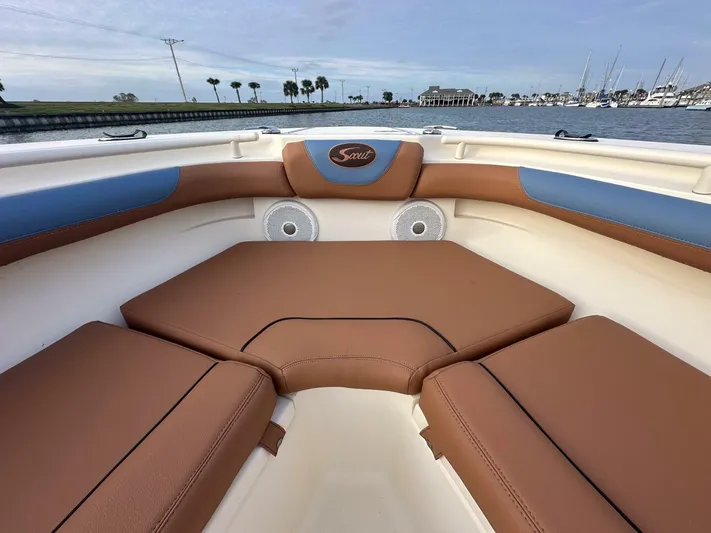 Knot Reel Serious Yacht Photos Pics 2015 Scout 320 LXF boat interior with brown seating and waterfront view.
