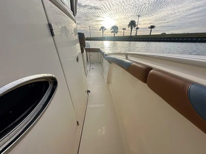 Knot Reel Serious Yacht Photos Pics 2015 Scout 320 LXF boat deck with sunset view over water.