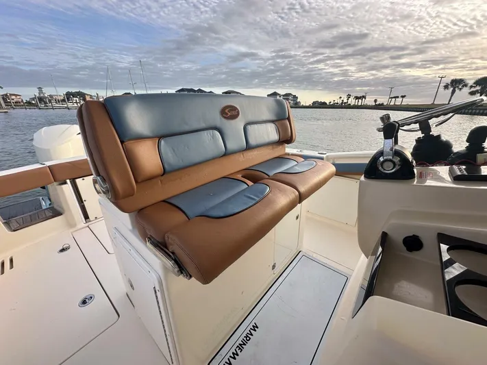Knot Reel Serious Yacht Photos Pics 2015 Scout 320 LXF boat interior with leather seating and waterfront view.