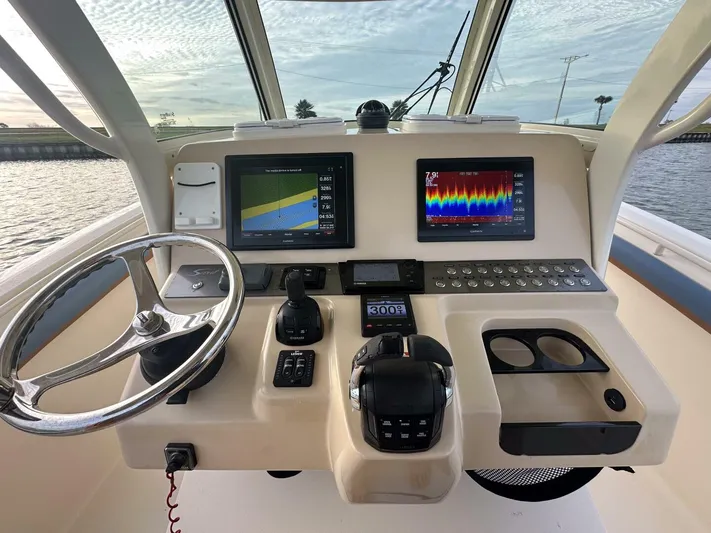 Knot Reel Serious Yacht Photos Pics Helm of 2015 Scout 320 LXF boat with dual navigation screens and controls.
