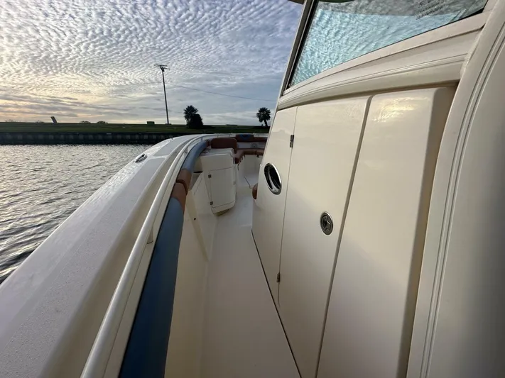 Knot Reel Serious Yacht Photos Pics 2015 Scout 320 LXF boat side deck view at sunset.