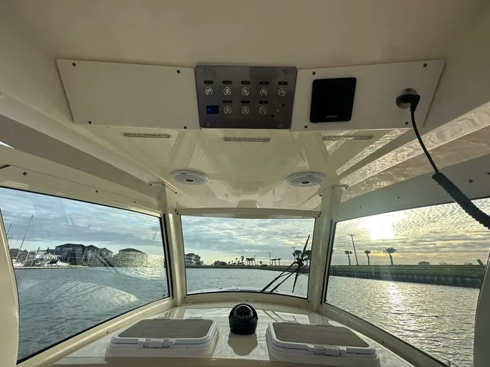 Knot Reel Serious Yacht Photos Pics Interior view of 2015 Scout 320 LXF boat with waterfront scenery.
