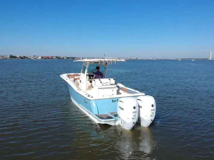 Knot Reel Serious Yacht Photos Pics 2015 Scout 320 LXF boat with twin Yamaha engines on calm water.