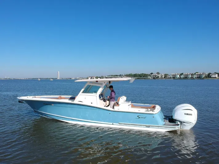 Knot Reel Serious Yacht Photos Pics 2015 Scout 320 LXF boat cruising on a calm blue sea.
