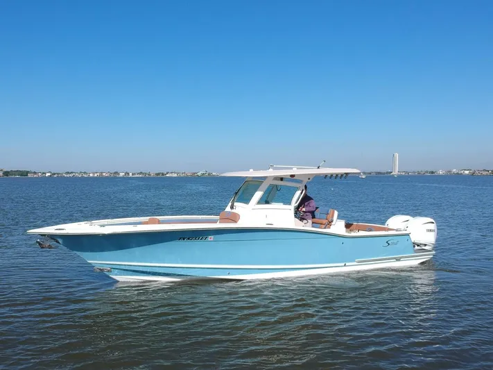Knot Reel Serious Yacht Photos Pics 2015 Scout 320 LXF boat cruising on calm waters.
