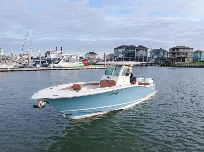 Knot Reel Serious Yacht Photos Pics 2015 Scout 320 LXF boat on water near marina and waterfront homes.