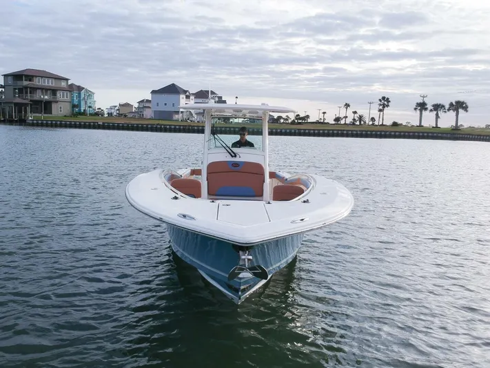 Knot Reel Serious Yacht Photos Pics 2015 Scout 320 LXF boat on calm water near coastal homes.