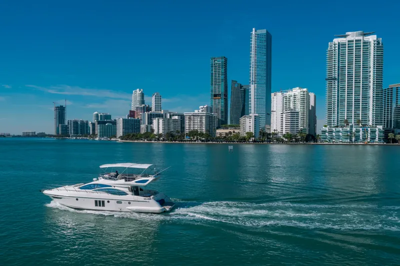 Prime Time Yacht Photos Pics Azimut 48 Flybridge yacht cruising near city skyline, 2012 model.