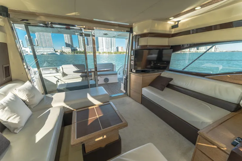 Prime Time Yacht Photos Pics Luxurious interior of 2012 Azimut 48 Flybridge yacht with city skyline view.