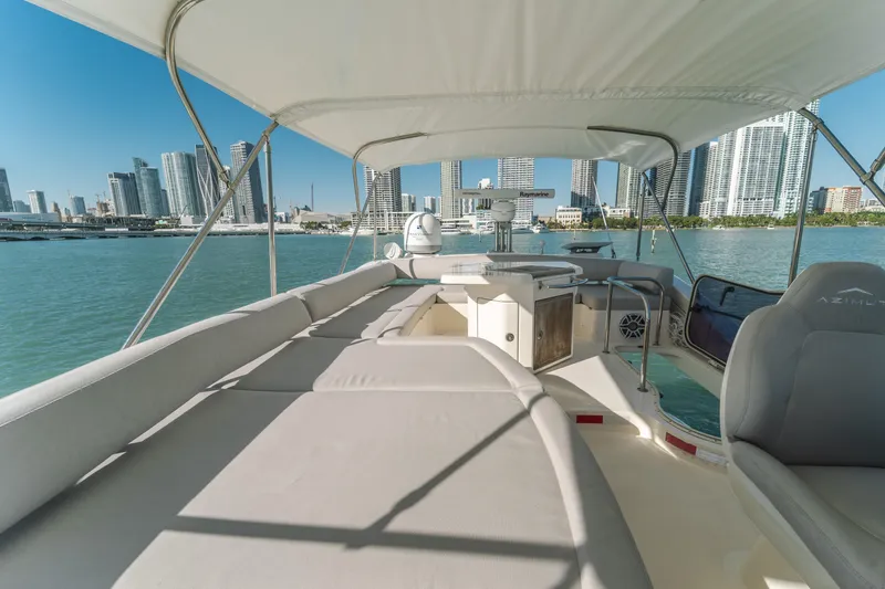 Prime Time Yacht Photos Pics Luxurious 2012 Azimut 48 Flybridge yacht with city skyline view, spacious deck, and elegant seating.