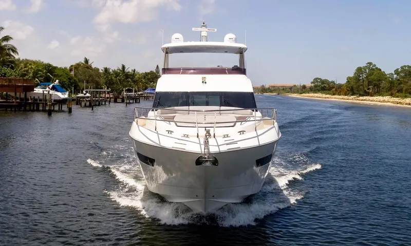 Clarity Yacht Photos Pics 2015 Princess Flybridge 68 Motor Yacht cruising on a scenic waterway.