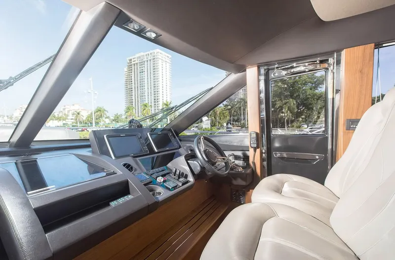 Clarity Yacht Photos Pics Interior cockpit of 2015 Princess Flybridge 68 Motor Yacht with modern controls and leather seating.