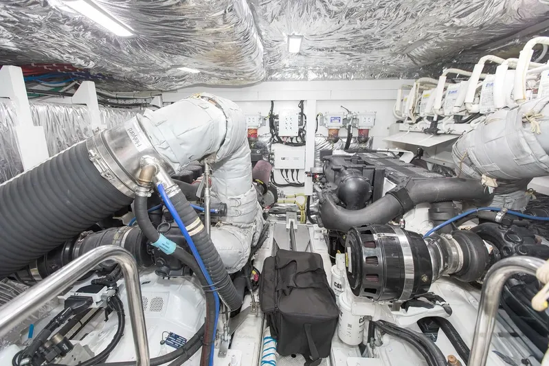 Clarity Yacht Photos Pics Engine room of 2015 Princess Flybridge 68 Motor Yacht, showcasing complex machinery and piping.