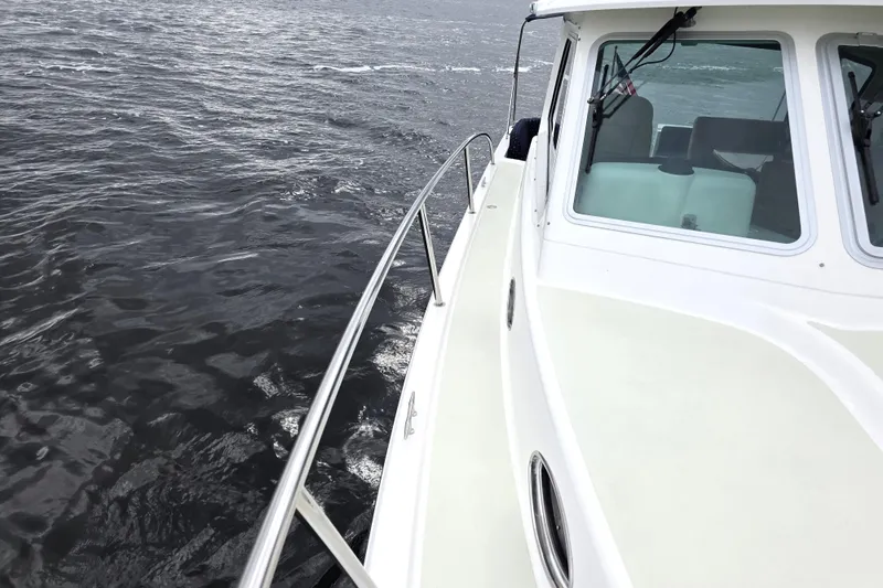 Jubilee Yacht Photos Pics 2018 Back Cove 32 boat cruising on open water, showcasing sleek design and cabin windows.