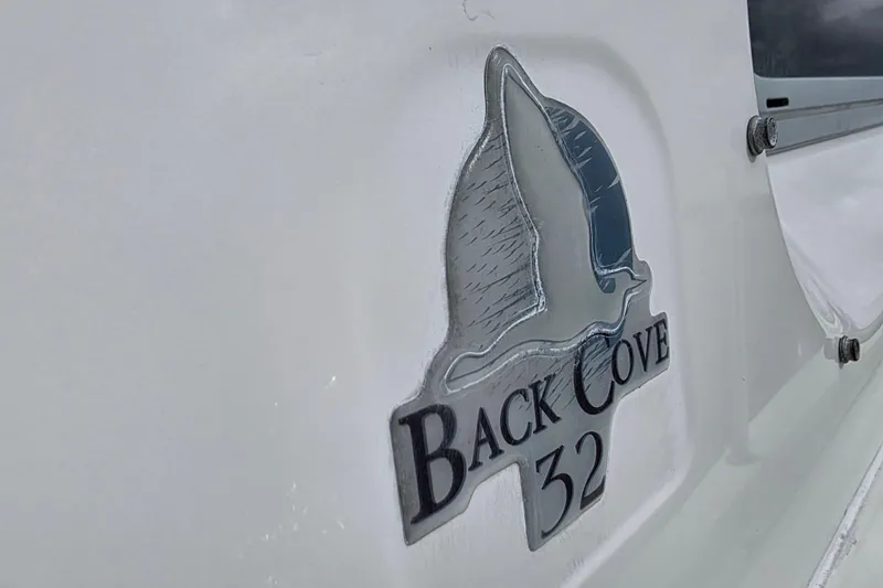 Jubilee Yacht Photos Pics Back Cove 32 logo on 2018 model boat, featuring a stylized seagull design.