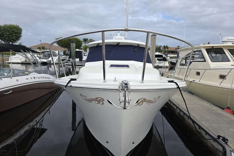 Jubilee Yacht Photos Pics 2018 Back Cove 32 boat docked at marina, front view with decorative emblem.