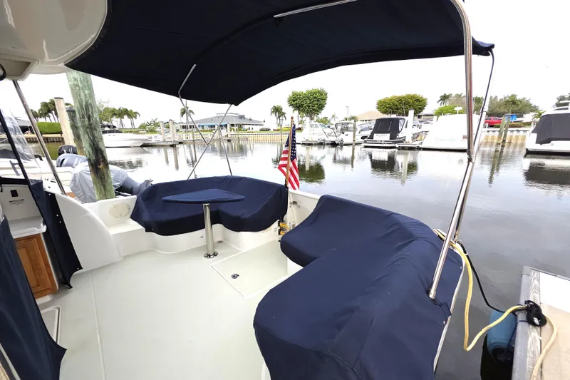 Jubilee Yacht Photos Pics 2018 Back Cove 32 boat with covered seating area at a marina.