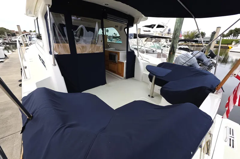 Jubilee Yacht Photos Pics 2018 Back Cove 32 boat interior with navy covers and docked marina view.