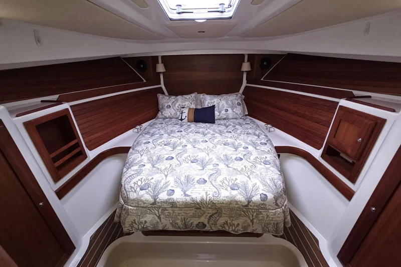 Jubilee Yacht Photos Pics Luxurious cabin interior of 2018 Back Cove 32 yacht with elegant bedding and wood accents.