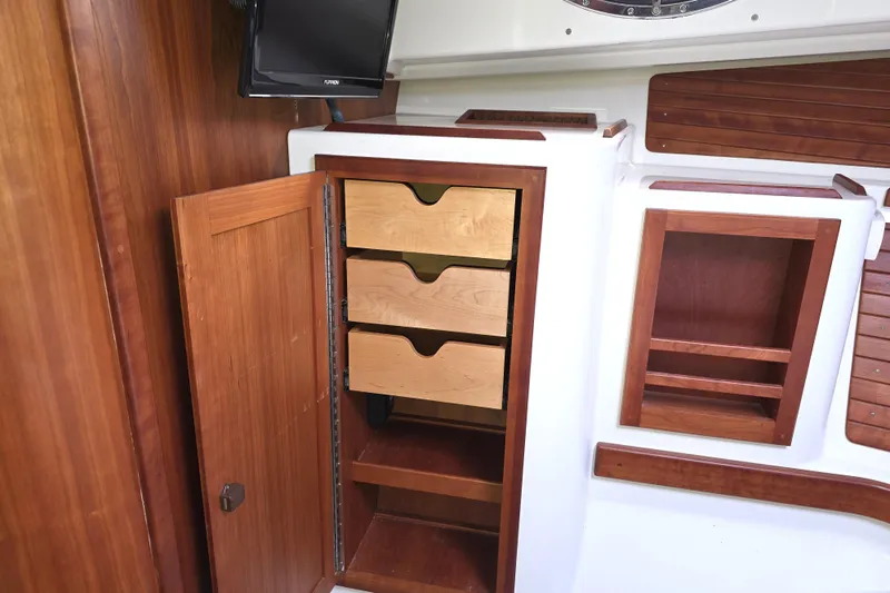 Jubilee Yacht Photos Pics Interior of 2018 Back Cove 32 boat with wooden cabinetry and storage drawers.